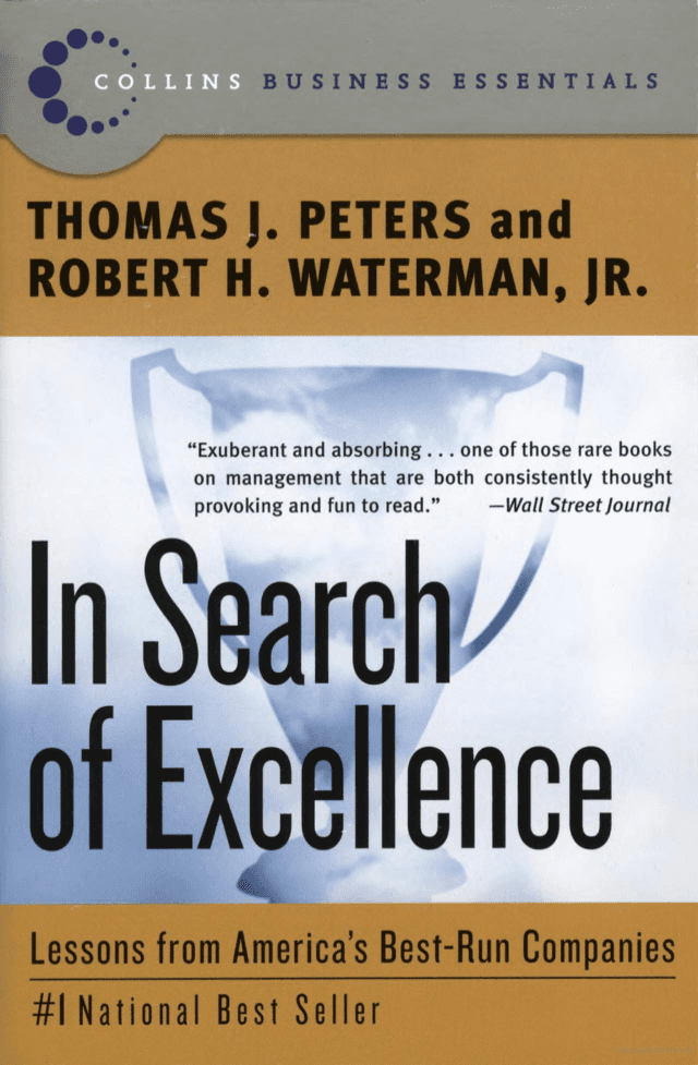 R.K. Baliga at his desk with the book 'In Search of Excellence'